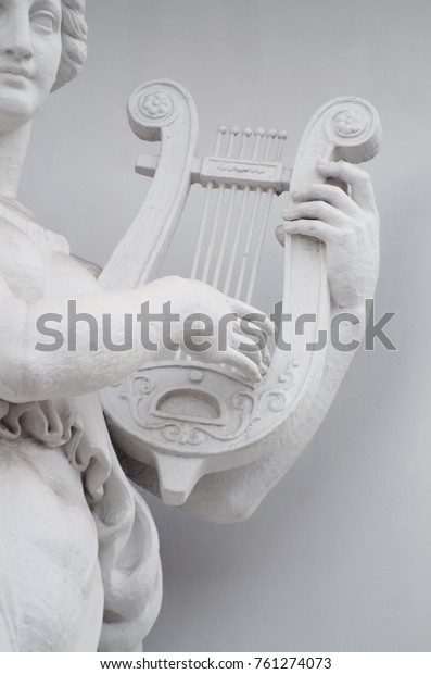 Sculpture of woman with lyre.Sculpture of\
woman with lyre.The statue is made of\
gypsum.