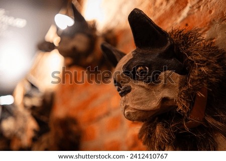 Sculptured dog heads on a brick wall interior