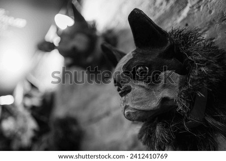 Sculptured dog heads on a brick wall interior in black and white