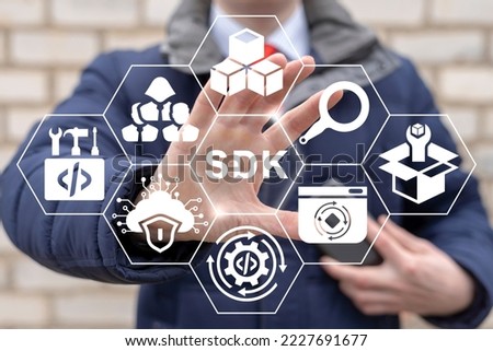 SDK Software Development Kit Сoncept. Businessman using virtual touchscreen represents abbreviation: SDK.