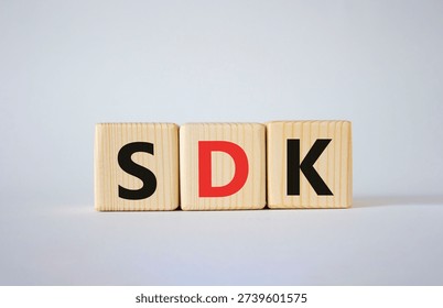 SDK - software development kit. Wooden cubes with word SDK . Beautiful white background. Business and software development kit concept. Copy space.