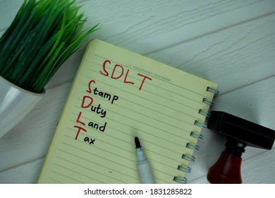 SDLT - Stamp Duty Land Tax Write On A Book Isolated On Office Desk.