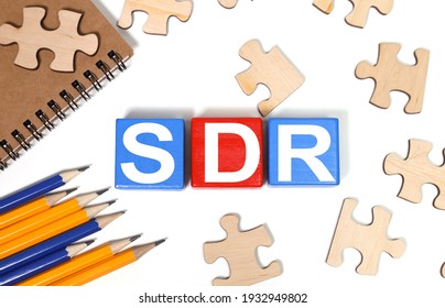 SDR Serpstat Domain Rank - text in black letters on wood blocks