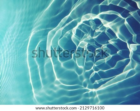 Reflection​ on​ surface​ blue​ water​ in​ the​ sea. Abstract​ of​ surface​ blue​ water​ for​ background. Closeup​ abstract​ of​ surface​ blue​ water. Splash​ed​ water​ in the​ swimming​pool. Water​