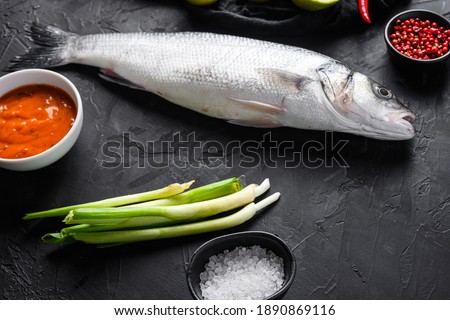 Similar – fresh whole sea bass fish on a black board