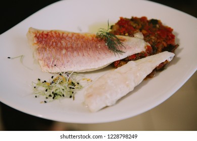 A Sea Bass With Vegatables Ratatouille Fish On The White Plate 