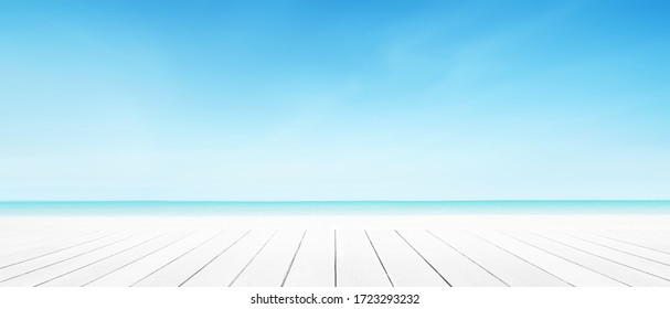 Sea beach background with white wood panel floor foreground. Landscape cloud blue sky summer.