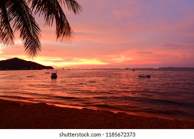 Sea and beach in the evening. The sun, orange and red reflect on the sea. - Shutterstock ID 1185672373