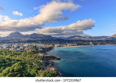 Sea beach forest mountains and clouds with blue sky. Wide landscape view. Scenic view. 