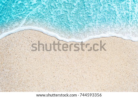 Sea Beach and Soft wave of blue ocean.  Summer day and sandy beach background
