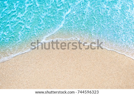 Sea Beach and Soft wave of blue ocean.  Summer day and sandy beach background concept.
