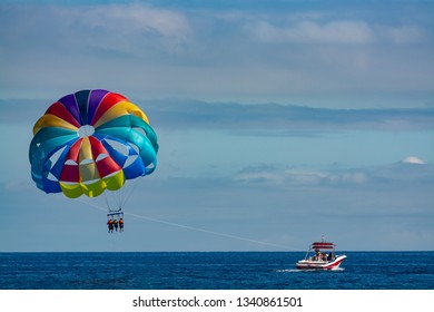 Sea and beach sport for tourists, parasailing in blue sky copy space