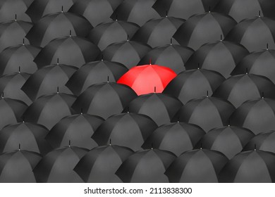 Sea of black umbrellas with one red umbrella in the center, symbolizing an idea, innovation, leadership, audacity, bravery. - Shutterstock ID 2113838300