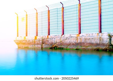 Sea Border. Old Barbed Wire Fence In The Sea. Obstacle, Restriction Of Movement. Illegal Border Crossing.