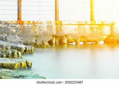 Sea Border. Old Barbed Wire Fence In The Sea. Obstacle, Restriction Of Movement. Illegal Border Crossing.