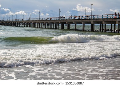 Sea Bridge in Palanga. Palanga Pier. Stormy Weather on the Beach. Green Waves. Stormy Sea. Dramatic Landscape with Stormy Sky and Waves. City Pier 