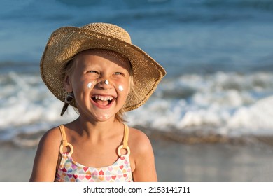 Sea Child Portrait on Sea Background. Happy Laughing Kid with Sunscreen on Face. Happy Holiday on Sea Beach. Children at Sea Coast. 