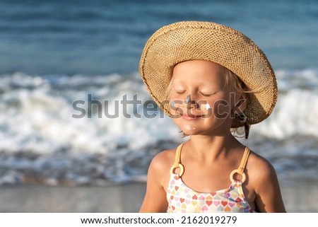 Sea Children Holiday. Sea Kids Portrait on Sea Background. Happy Child Tanning Sunbathing with Sunscreen on Face on Sea Coast. Children Sunscreen Care.