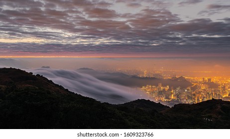 Sea Of Clouds Go Towards Hong Kong City At Dawn, View At Mountain Top