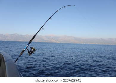 Sea Fishing From Steel Fishing Boat On Open Water. Sunny Day At Sea And Fishing