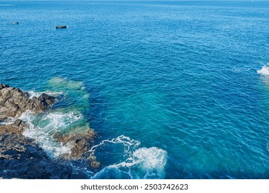 Sea foam and Atlantic Ocean waves crashing against the rocks in Los Gigantes Tenerife Spain - Powered by Shutterstock