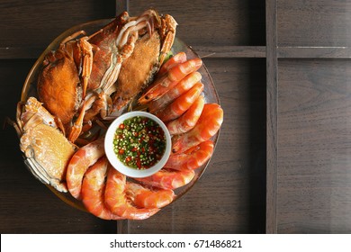 Sea Food Include Shrimp , Crab In The Plate On The Wood Table. Top View