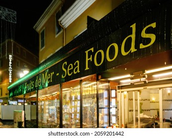 Sea Foods Signage On The Protection From Rain Awning On The Supermarket Restaurant Entrance At Night In French City Of Nice