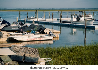 Sea Isle City, New Jersey - July 05, 2021: Dock With Multiple Boats On The Bay With Pleasant Cloud Coverage