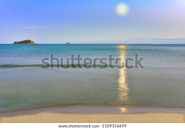 Sea of\
Japan. Evening landscape with moon overlooking the island of\
Chikhachev, Primorsky Krai, far East,\
Russia