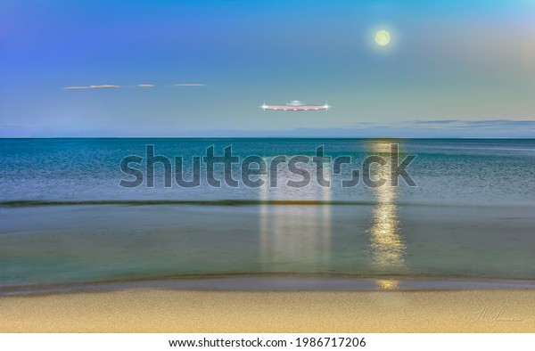Sea of\
Japan. Evening landscape with moon overlooking the island of\
Chikhachev, Primorsky Krai, far East,\
Russia