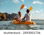 Sea kayaking or canoeing concept with young couple kayakers at tropical bay. Phranang bay, Krabi, Thailand