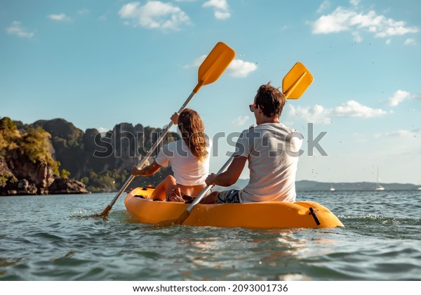 Sea kayaking or\
canoeing concept with young couple kayakers at tropical bay.\
Phranang bay, Krabi,\
Thailand
