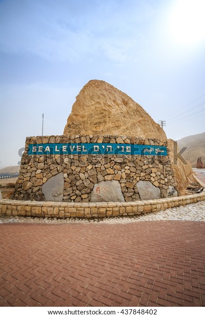 Sea level sign written in 3 languages approaching\
Dead Sea, Israel