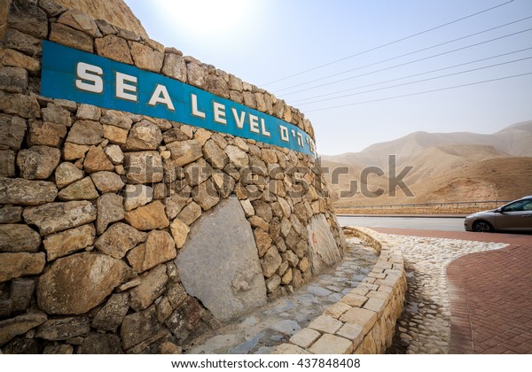 Sea level sign written in 3 languages approaching\
Dead Sea, Israel