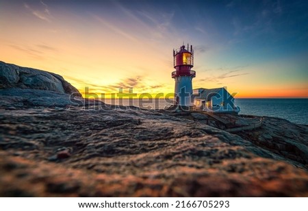 Sea lighthouse at beautiful dawn background