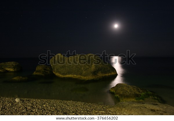 Sea, lunar path,\
stones.