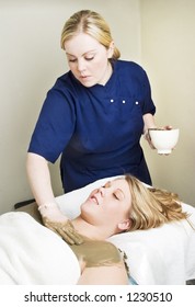 A Sea Mud Full Body Wrap Being Applied To The Chest Area At A Luxury Spa.