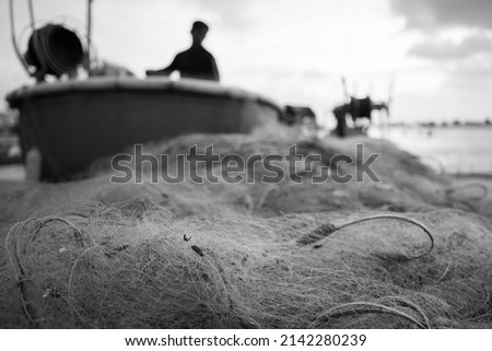 Sea nets - fishing equipment or tackle as texture backdrop with natural sunlight and shadow. Black and white textured background of fishing nets close-up, marine design for craft of fishermen.
