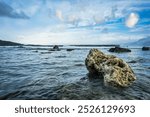 sea ​​rocks on the beach with views of the sea with beautiful breaking waves in the background