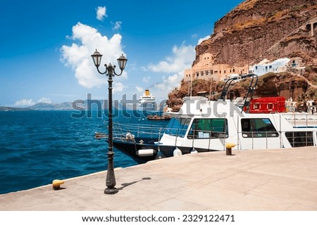 Sea port of Santorini island, Greece. Boat near the peer. Blue sea and the blue sky. Travel and vacation concept