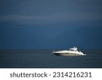 A Sea Ray Sundancer motor yacht on a voyage on a scenic blue sea