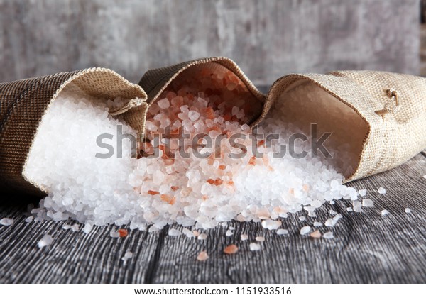 sea salt and himalayan in burlap. Crystals of salt\
on table