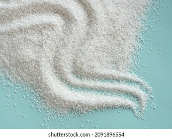 Sea salt scattered on a blue background, texture waves top view. Salt cave concept. Salt for the treatment of the respiratory tract. Place for your text. - Shutterstock ID 2091896554