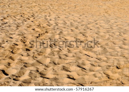 sea sand with footprints and feet