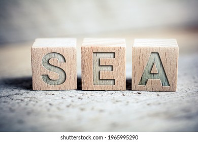 SEA Search Engine Advertising Written On Wooden Blocks On A Board - Business Marketing Concept