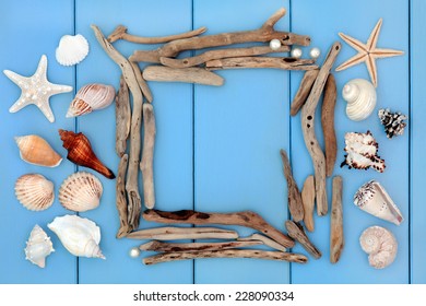 Sea Shell Collage And Driftwood Frame Over Wooden Blue Background.