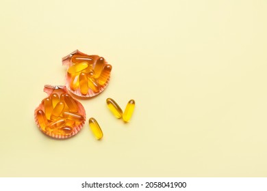 Sea Shells With Fish Oil Capsules On Color Background