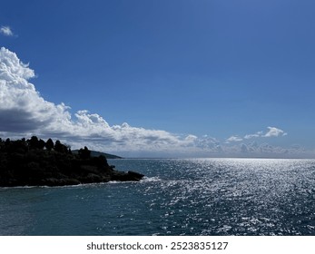 Sea shiny water, blue sky, amazing clouds and rocky coast scenic landscape.  - Powered by Shutterstock