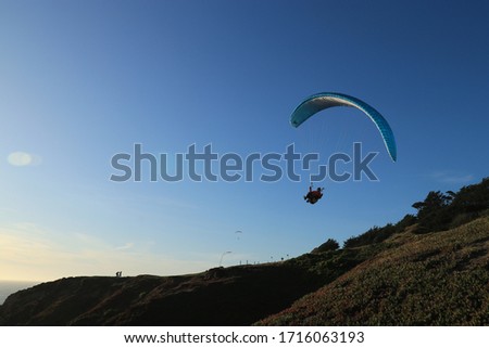 sea shore at daly city skyline, with paragliding 