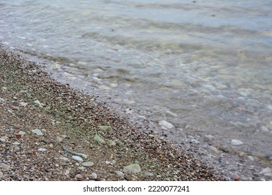 Sea Shore With Pure Water, Sand And Stones Isolated, Close-up